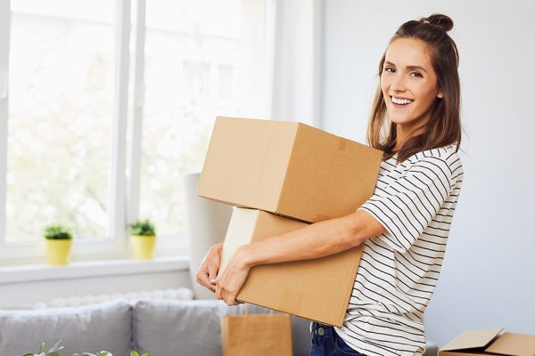 Cheerful woman holding two boxes